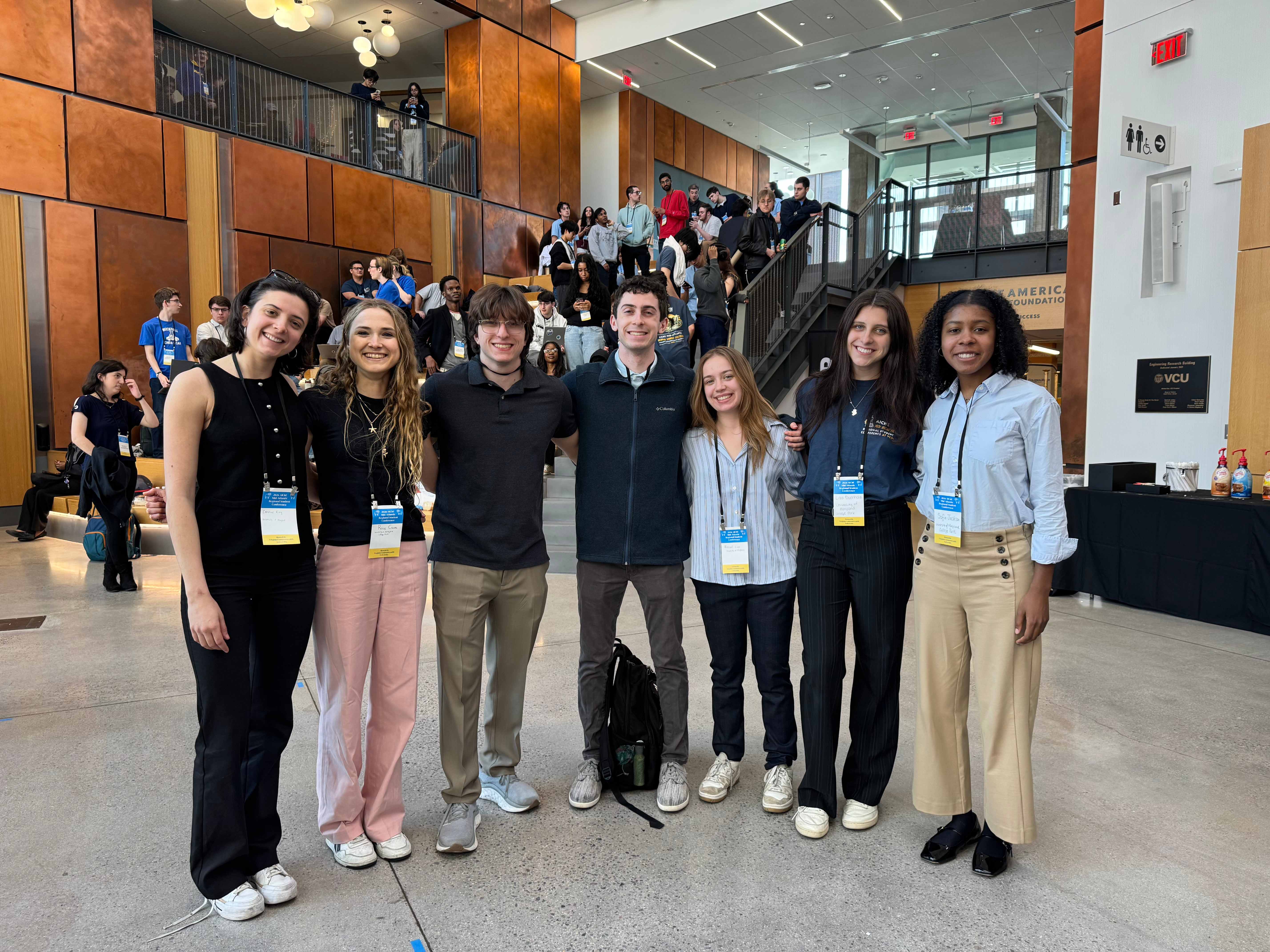 Group of seven students posing together at a student conference.